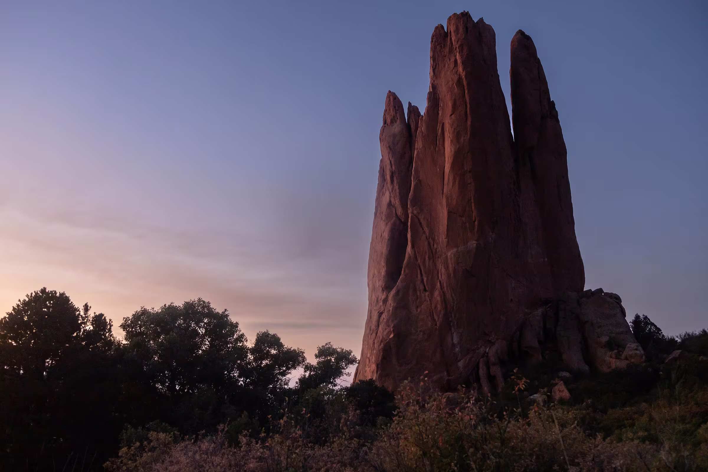 A red sandstone spire in Garden of the Gods, Colorado, at sunrise