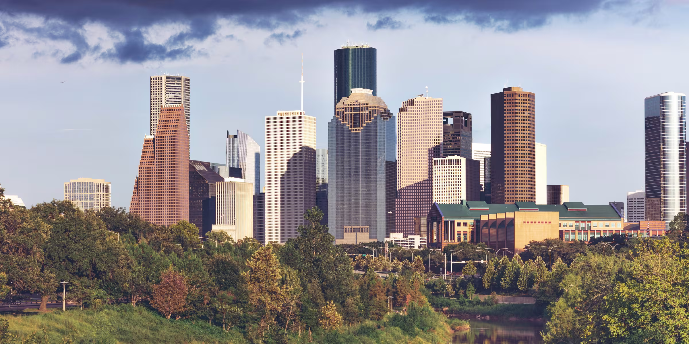The downtown Houston, Texas skyline above a bayou park